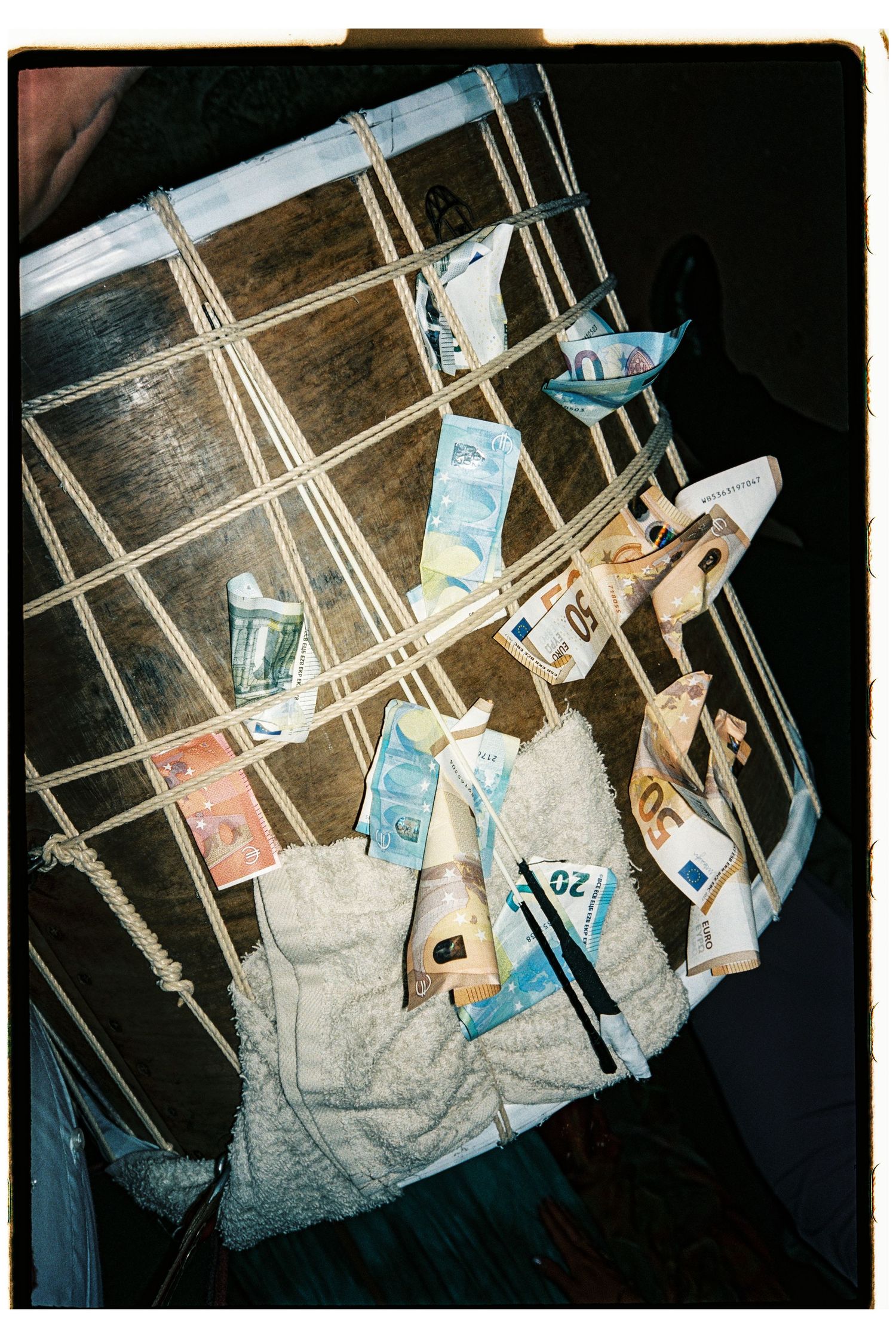 Euro banknotes tucked into a wooden grid frame as wedding money gift tradition.