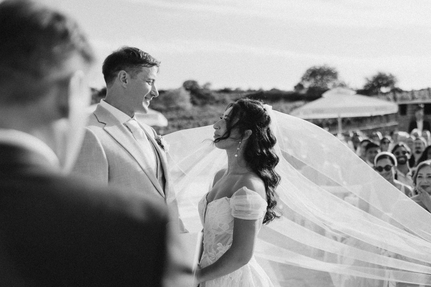 Black and white photos capture intimate moments between a couple during their wedding ceremony in Italy.