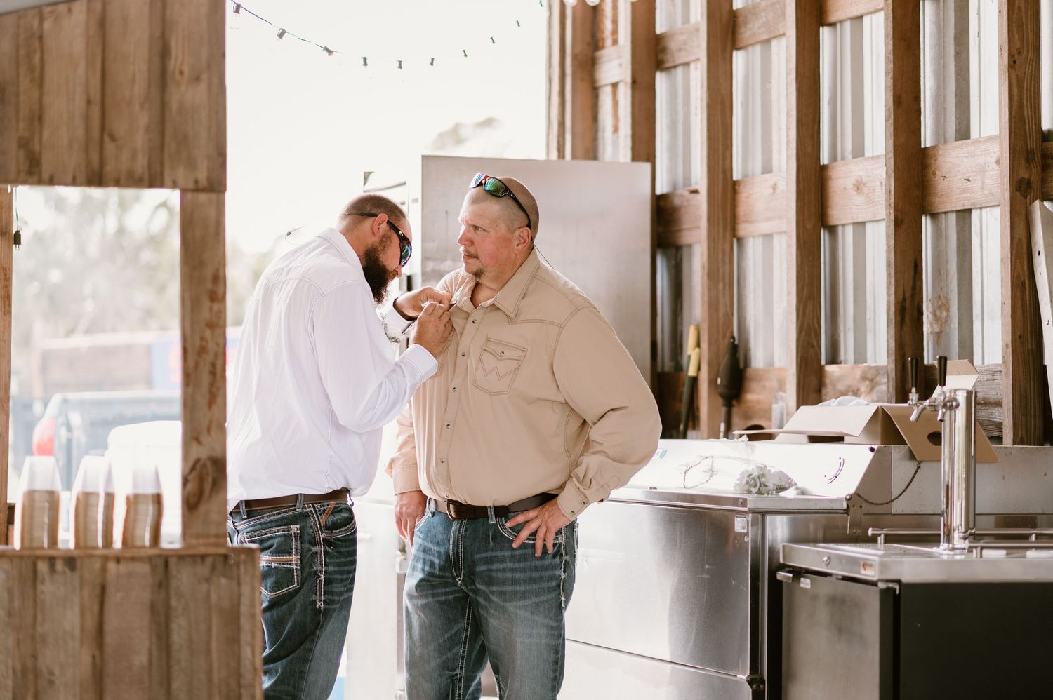 Interior venue shots showing rustic wood walls with string lights and casual gathering setup.