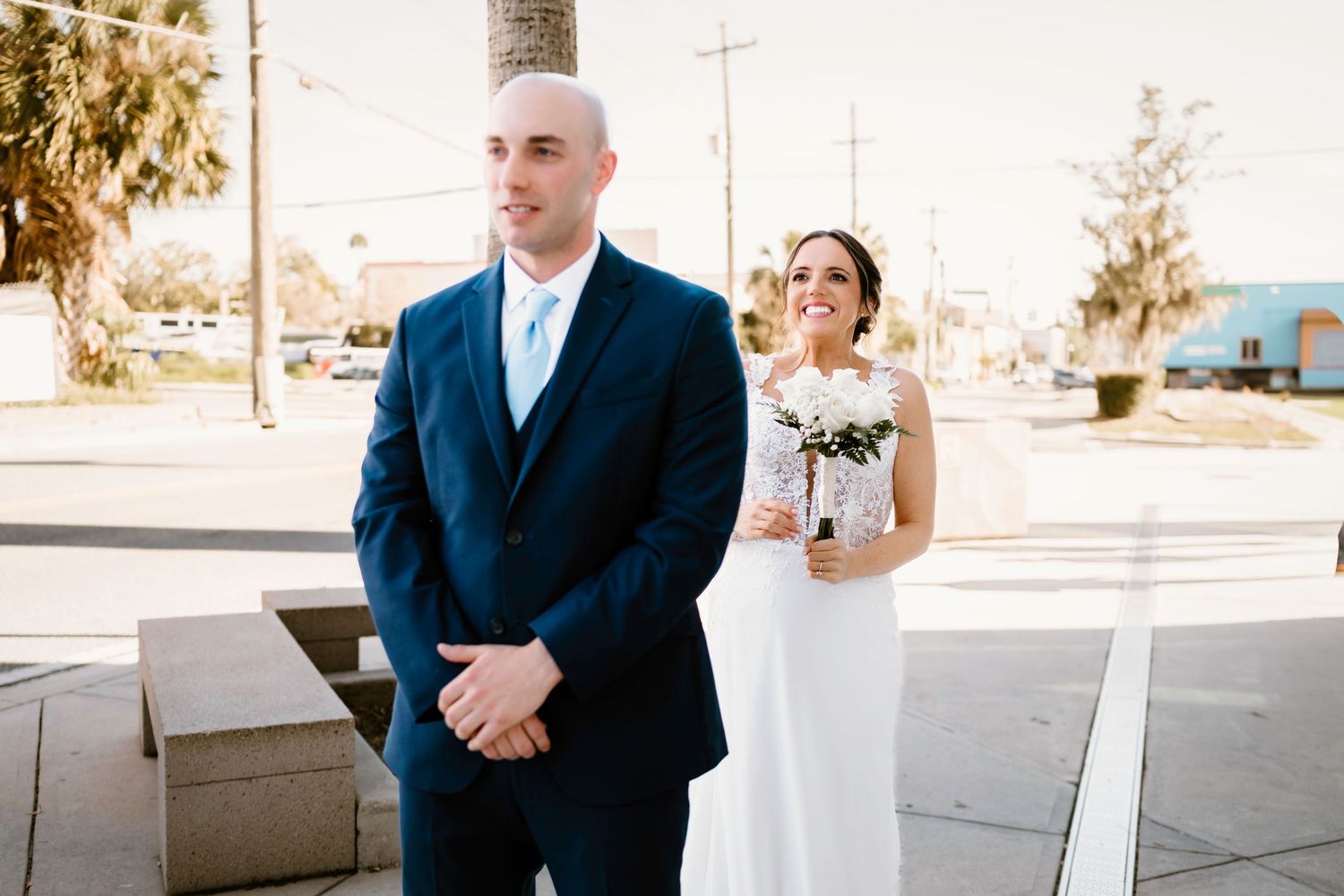 Wedding couple sharing intimate moments along a modern building exterior.