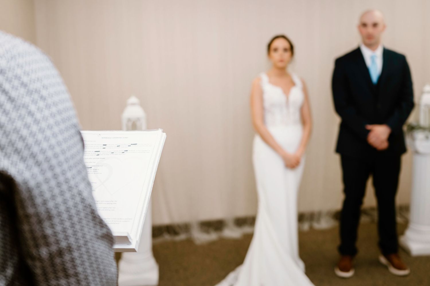 Indoor wedding photography session with elegant white decor and neutral background.