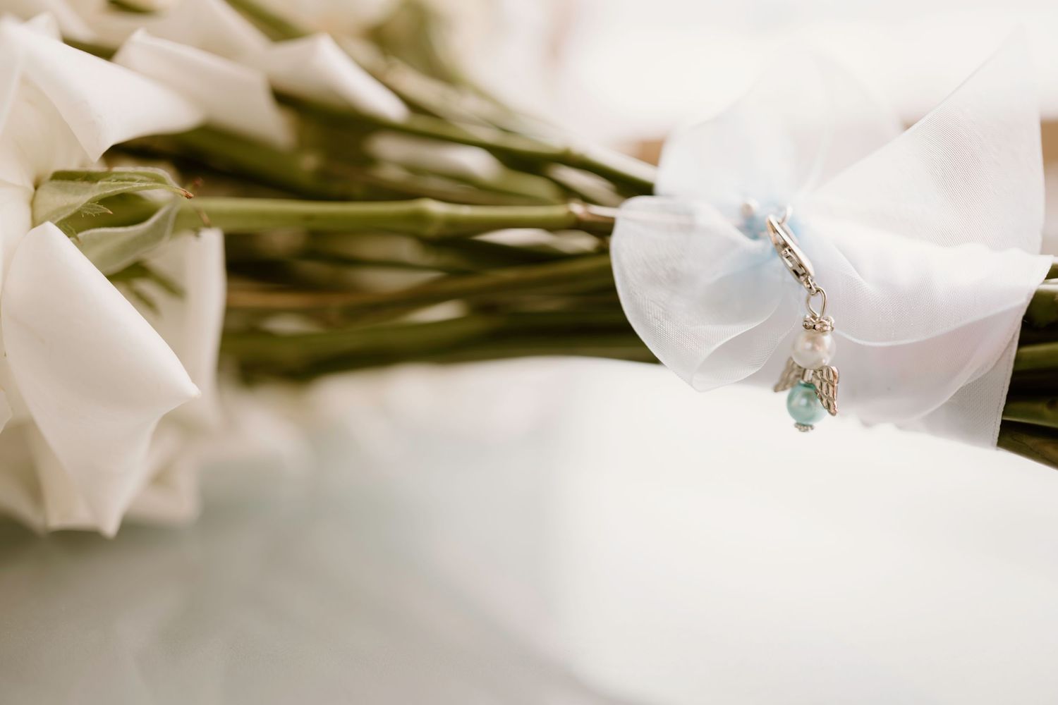 Delicate white flowers with a dainty bracelet charm detail.