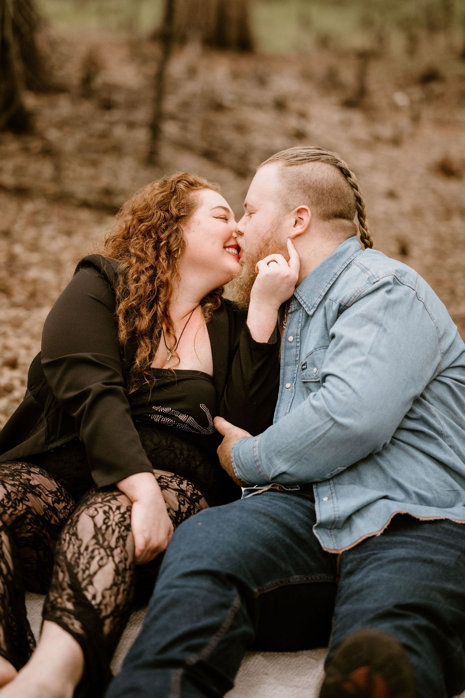 Romantic couple sharing intimate moments during outdoor photo session.