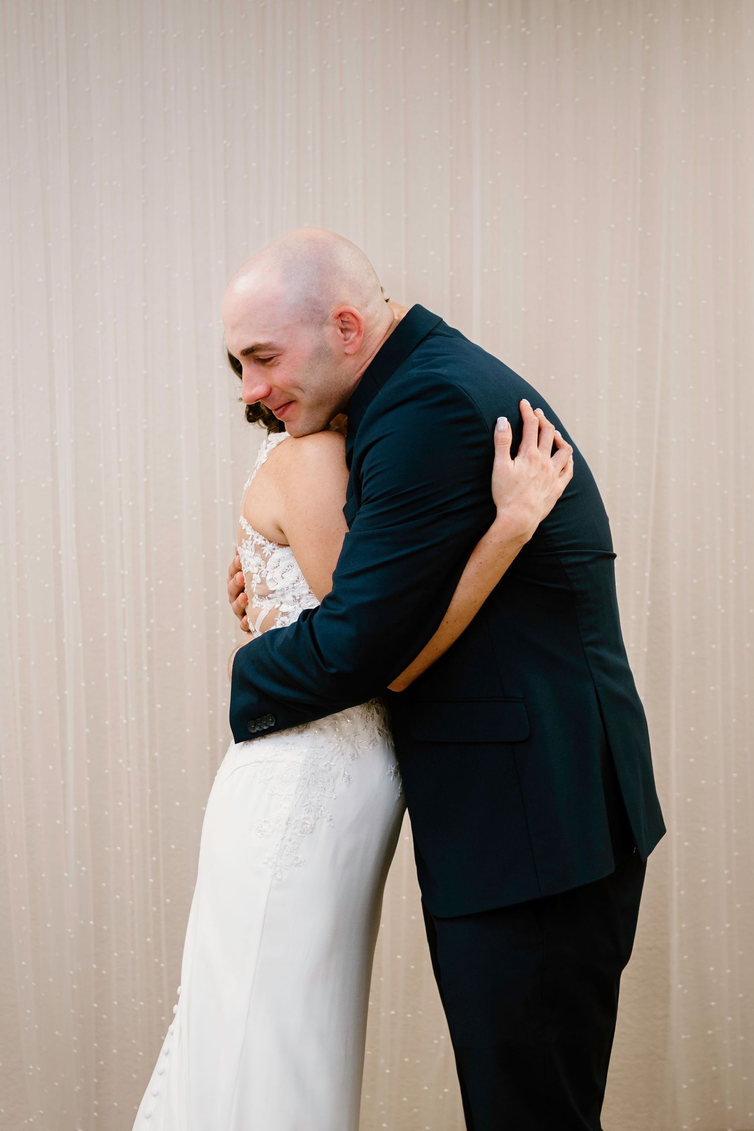 A series of intimate wedding photos showing tender embraces against a neutral backdrop.