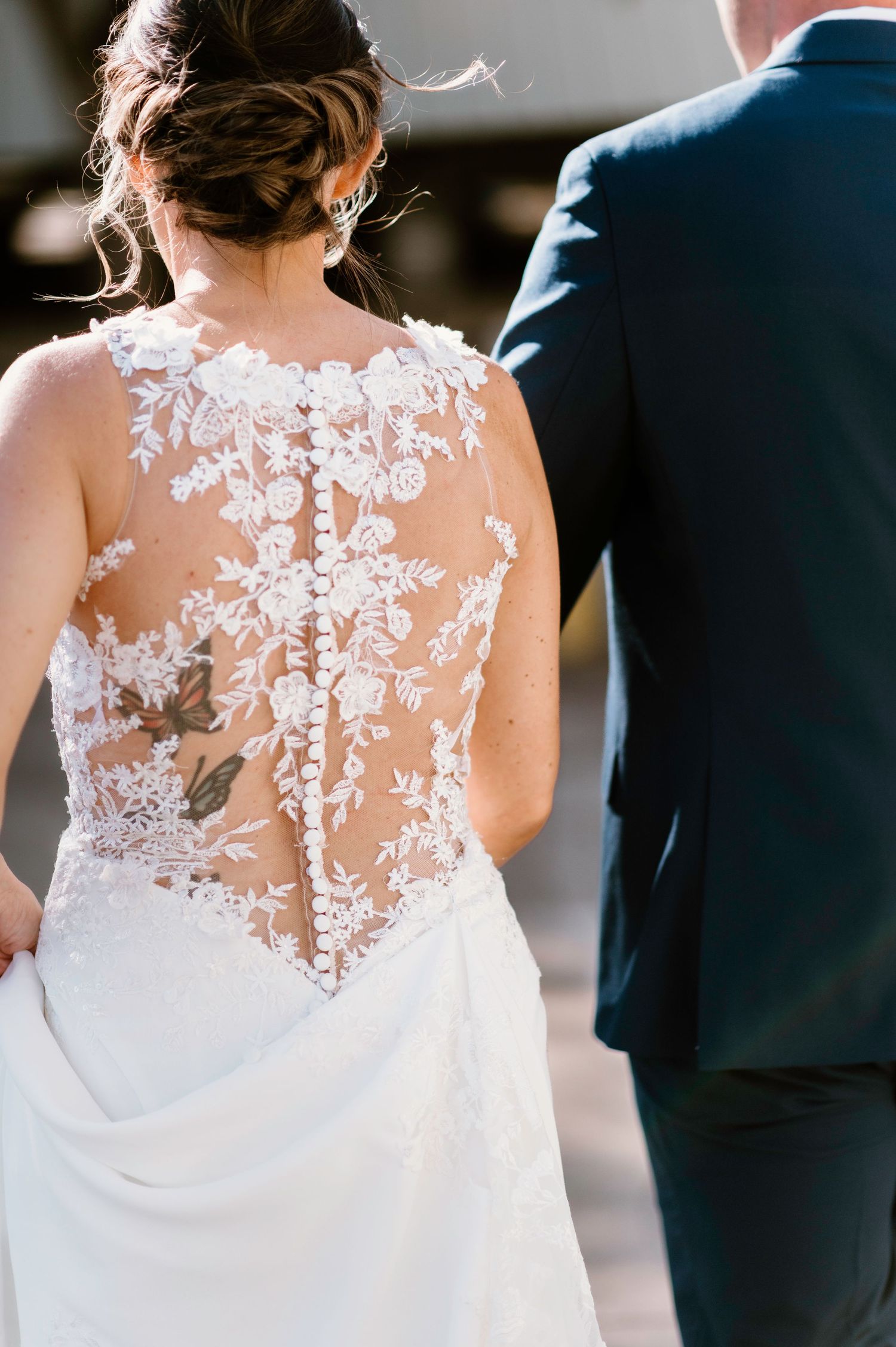 Intricate floral lace detail on the back of a white wedding gown.