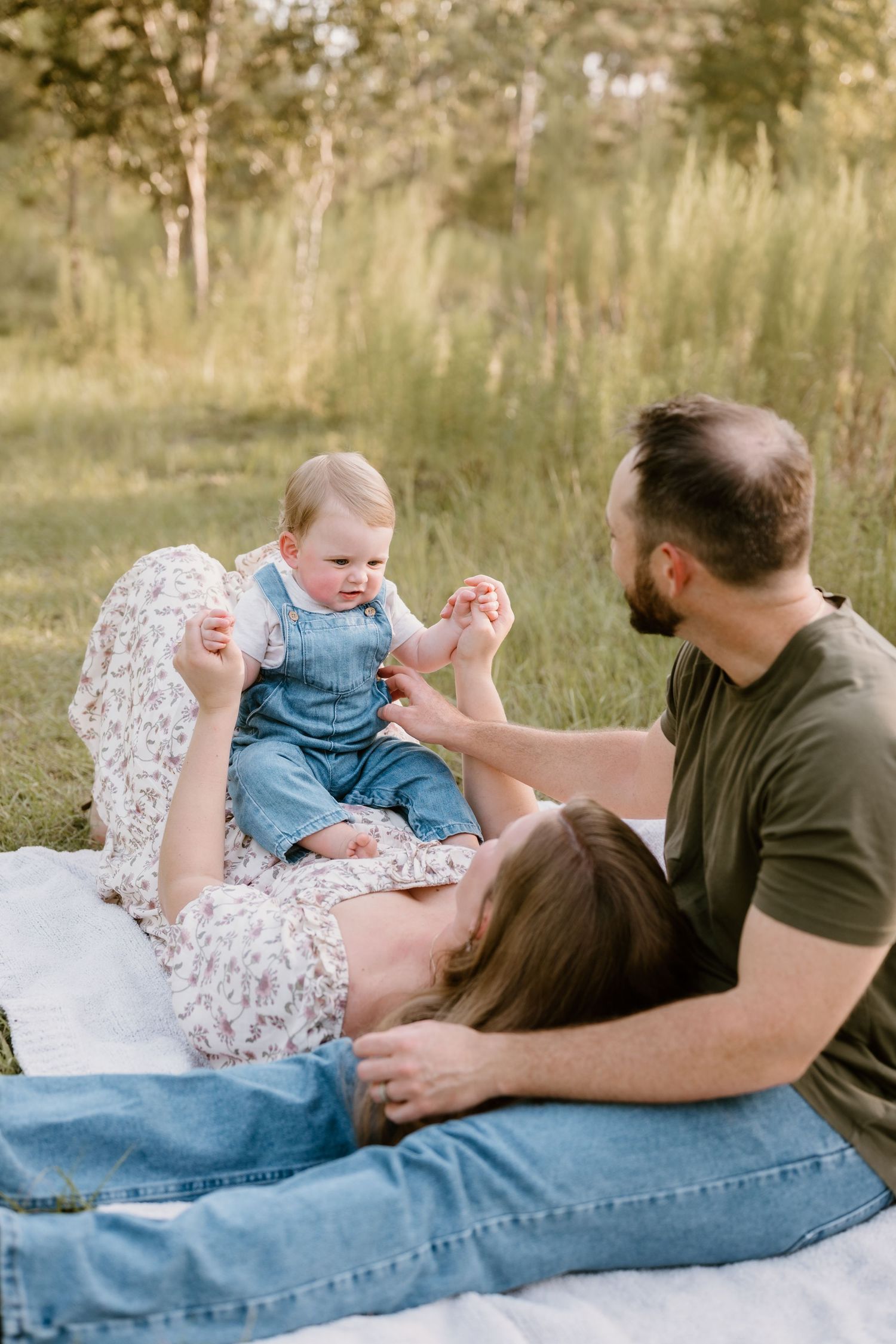 Series of candid moments showing a family playing together on a blanket outdoors.
