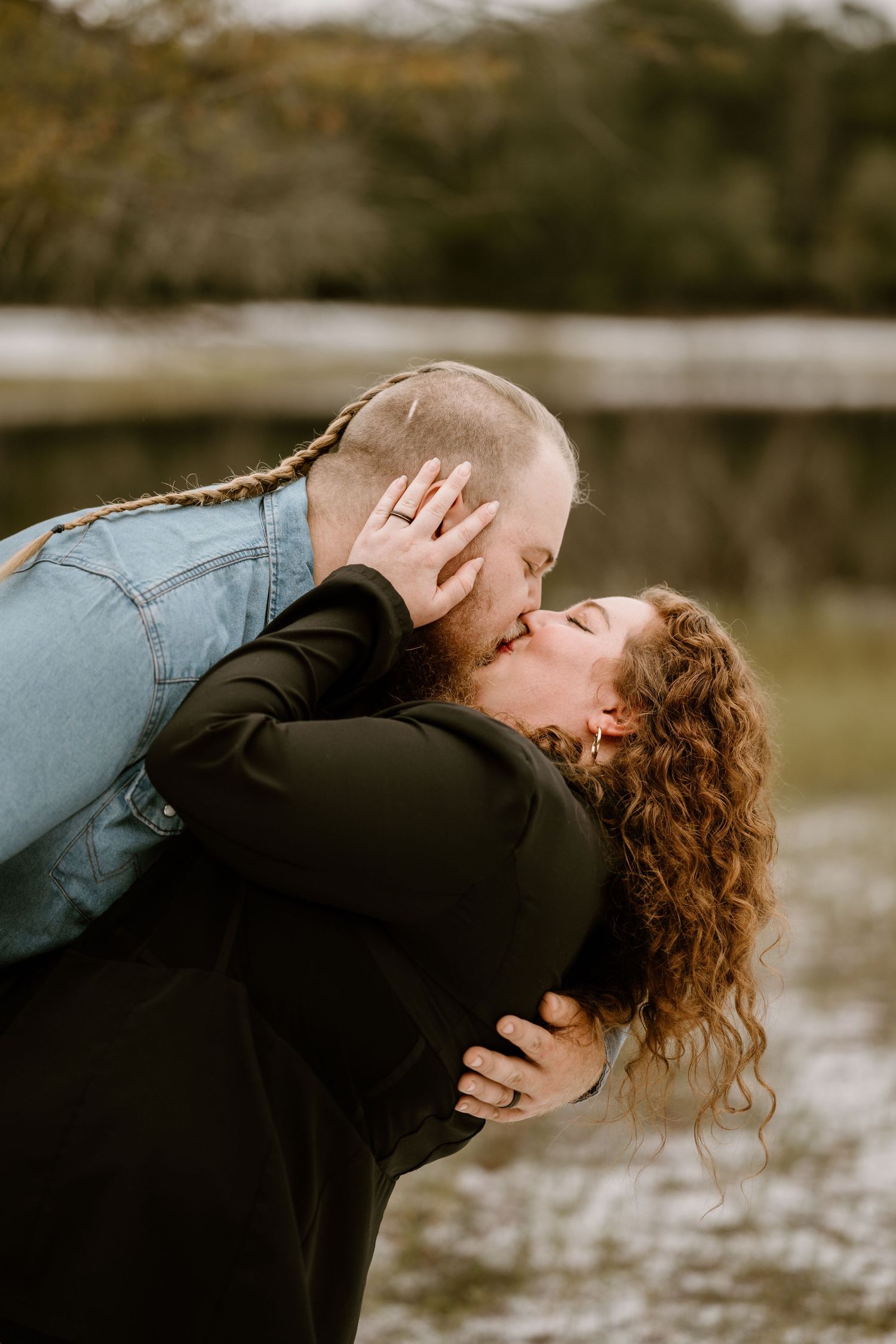 Romantic couple sharing tender moments in an outdoor setting.