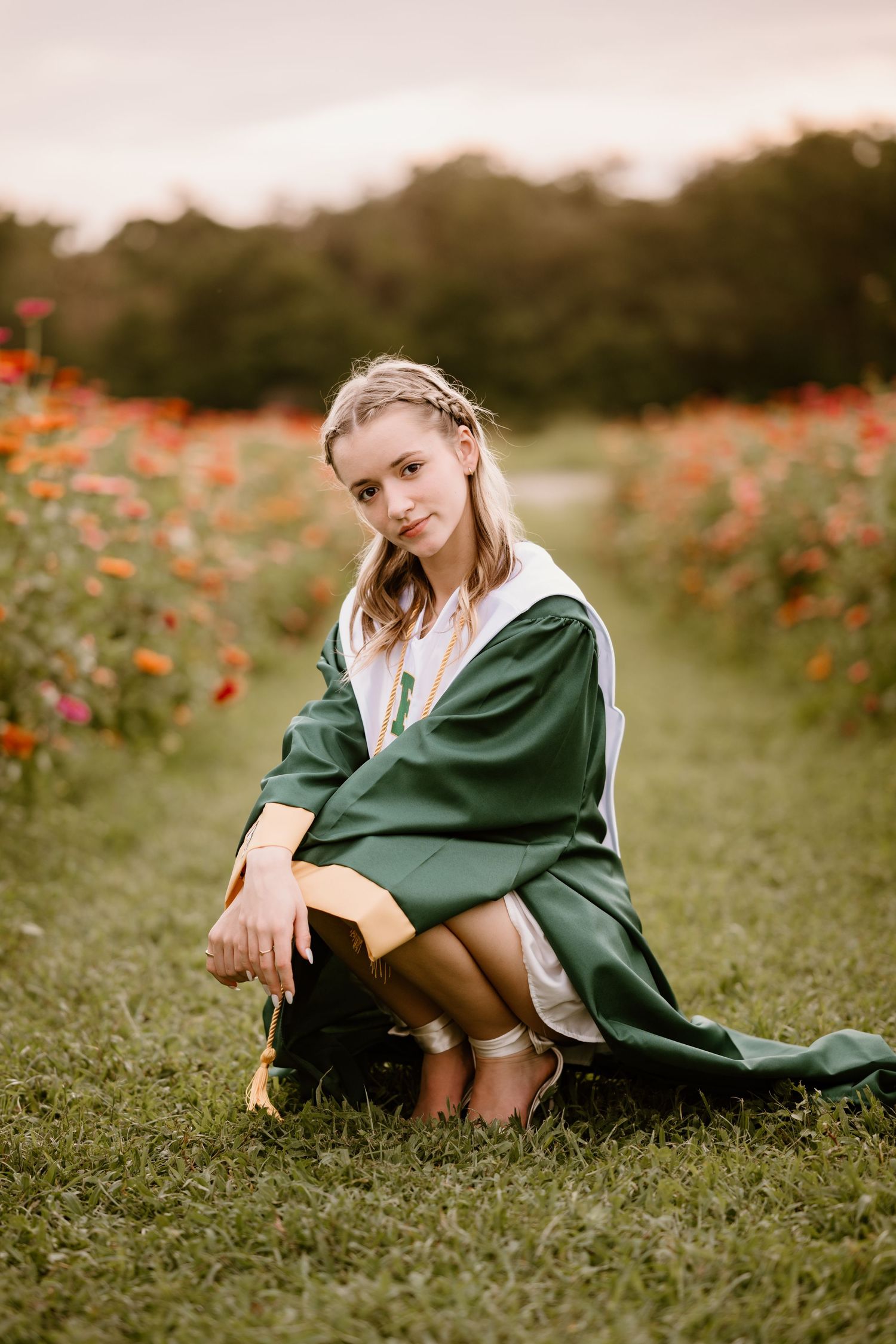 A casual outdoor portrait session among red wildflowers and green grass.