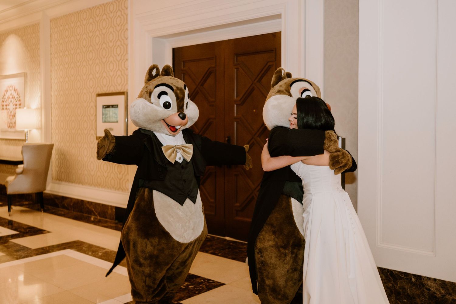 Disney character mascots dance with a bride in a white wedding dress.