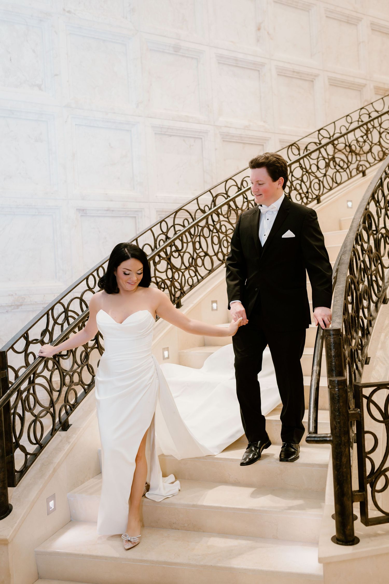 A sequence of four wedding photos showing a bride and her escort ascending an elegant staircase with ornate railings.