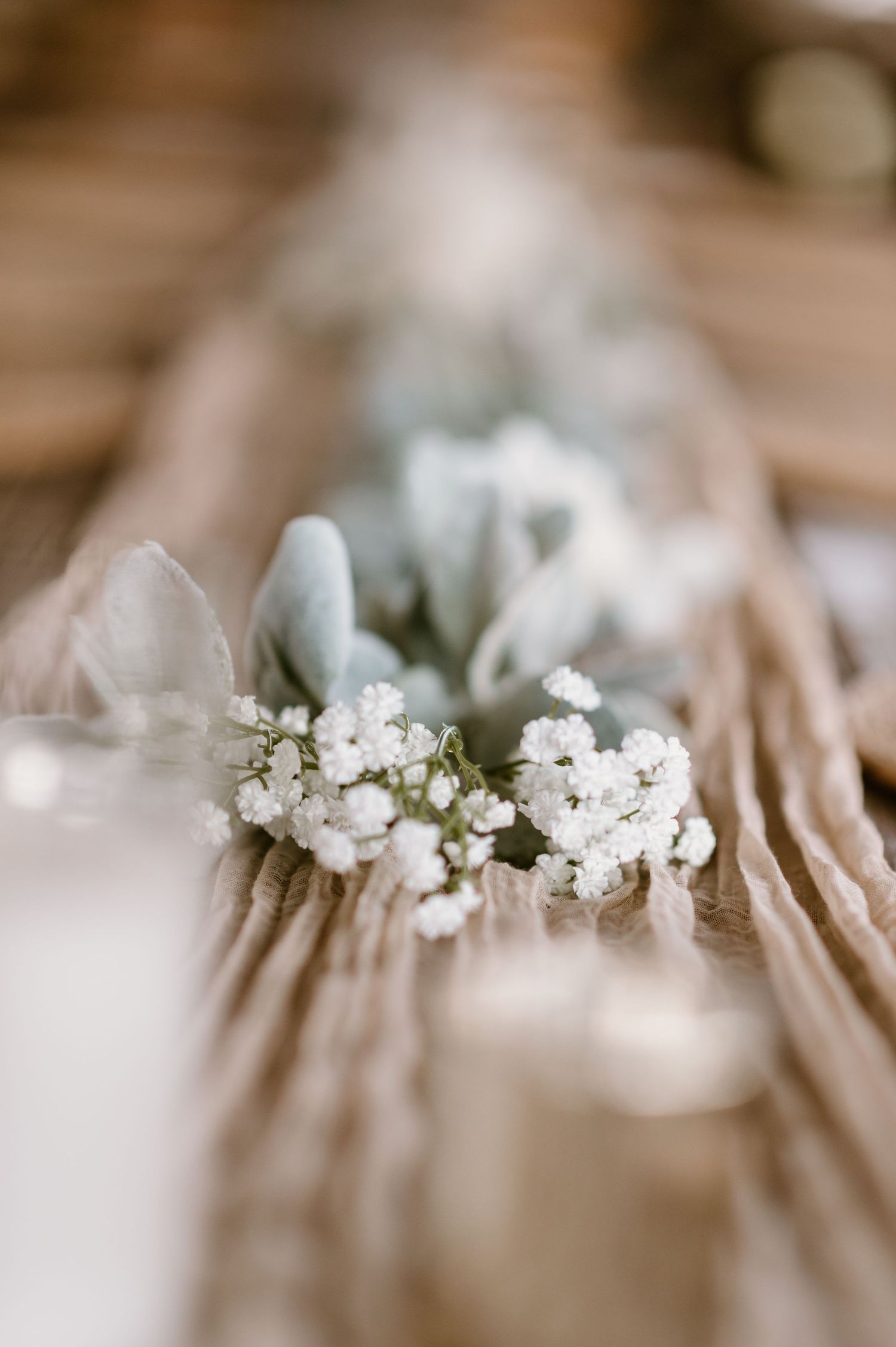 Delicate white baby's breath flower crown displayed on soft fabric.