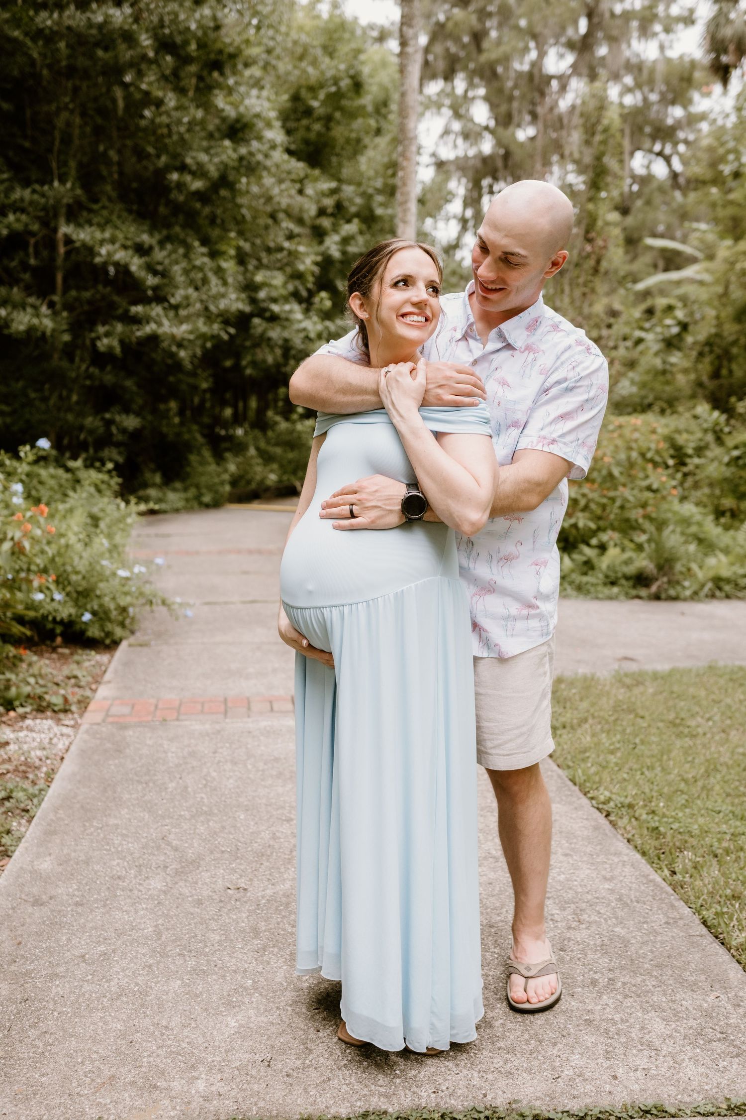 Sweet outdoor moments captured between family members in a light blue dress.