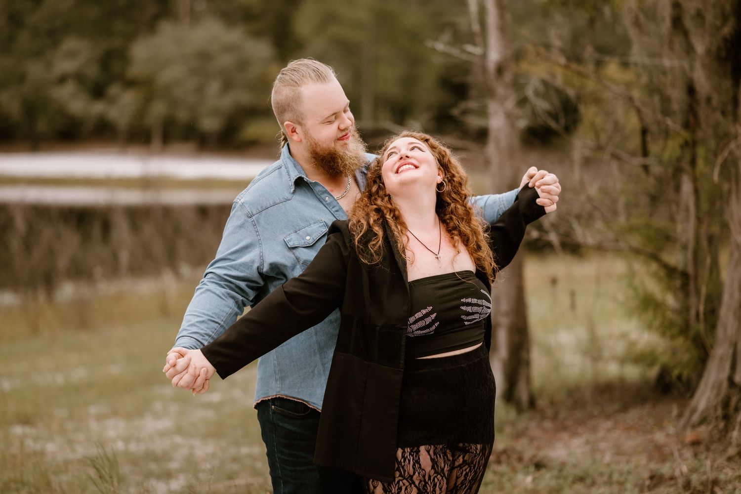 A couple dances and embraces outdoors during a romantic photoshoot.