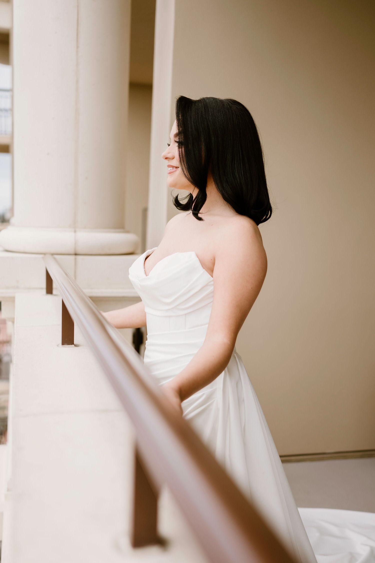 Classic white wedding dress captured from behind showing elegant backless design.