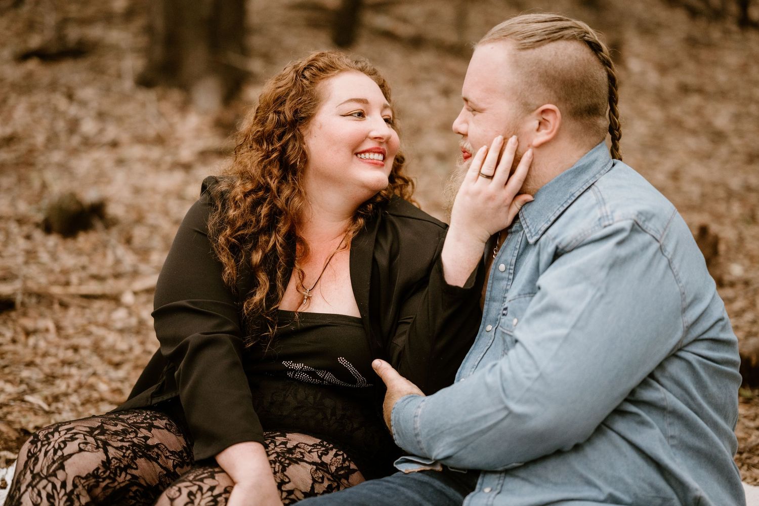Intimate couple portrait session with natural lighting and earthy background.
