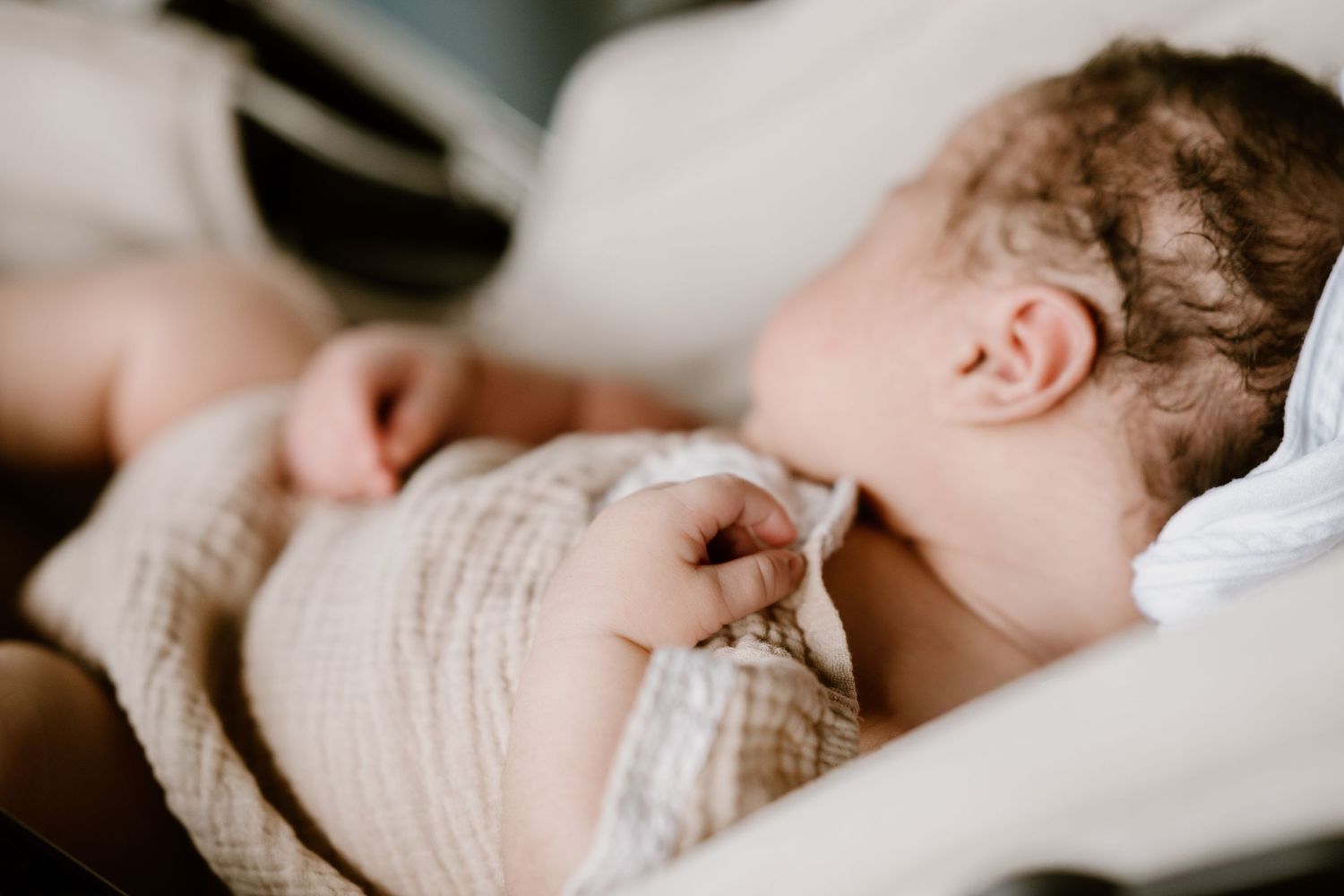 Peaceful sleeping newborn baby in soft natural lighting.