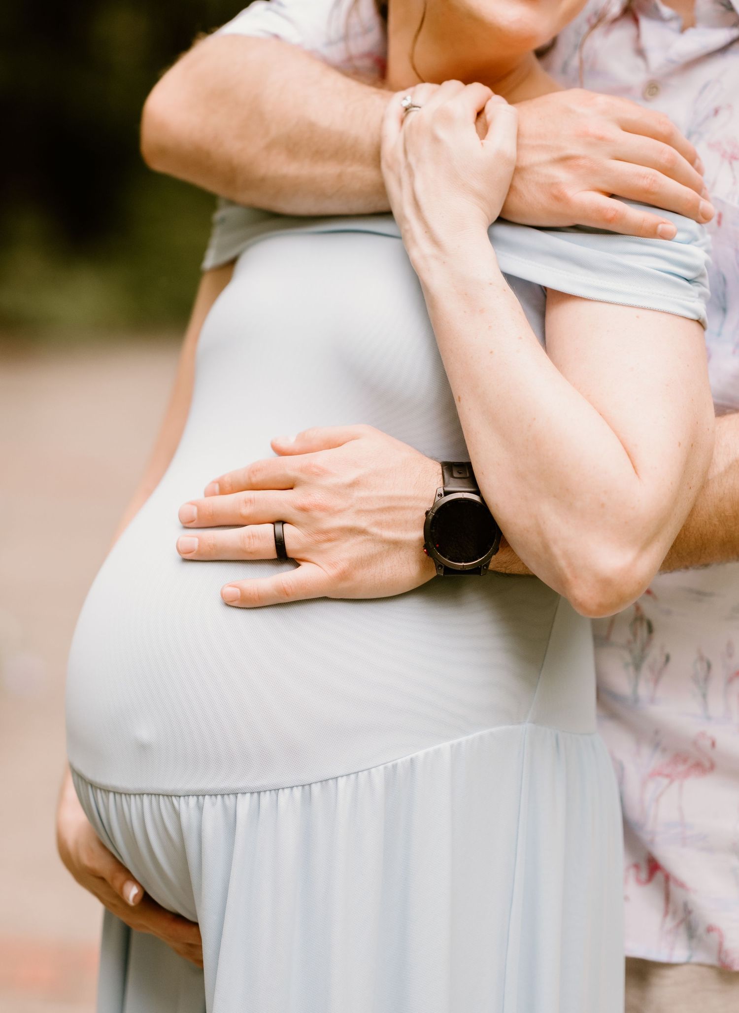 Close-up shots focusing on gentle hands cradling a pregnant belly in soft lighting.