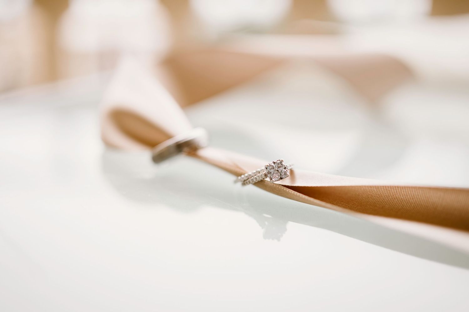 Macro close-up shot of wedding stationery details in soft focus.
