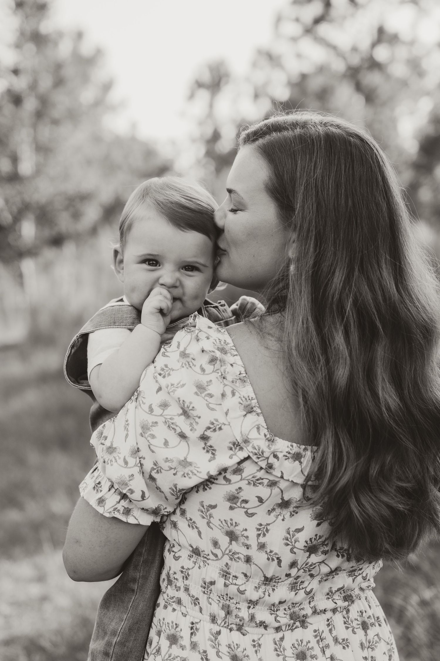 Intimate black and white portrait of parent and child sharing tender moment.