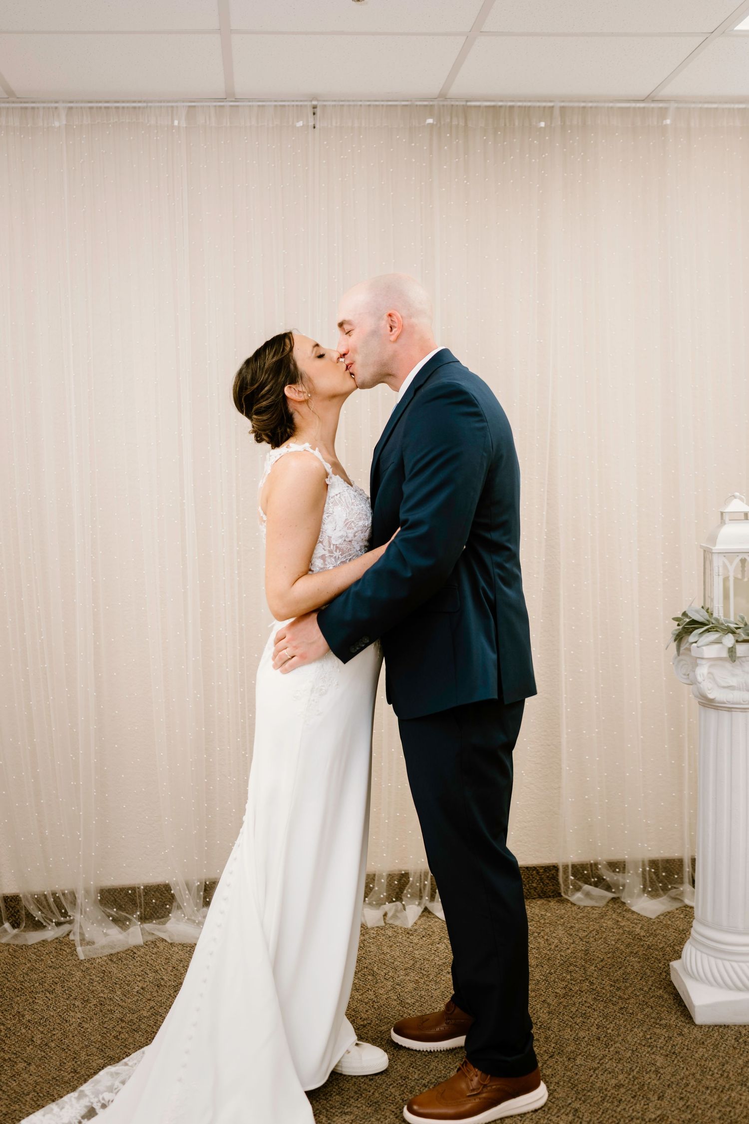 Romantic wedding moments captured in an indoor setting with neutral decor.