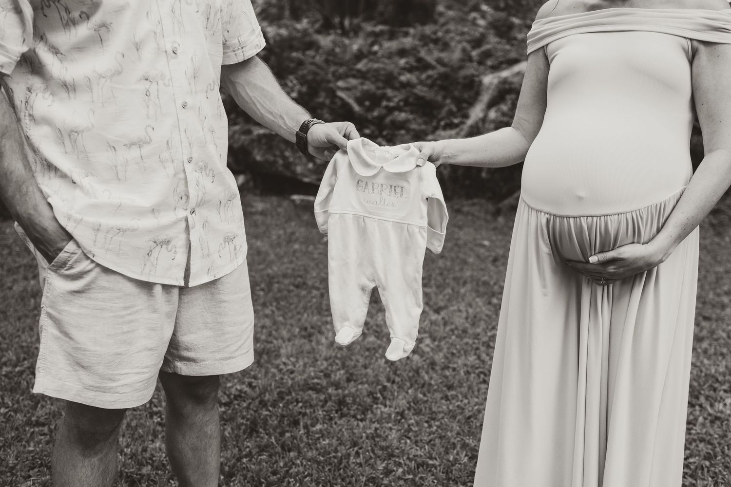 Maternity photo session showing expecting couple in white outfits outdoors.