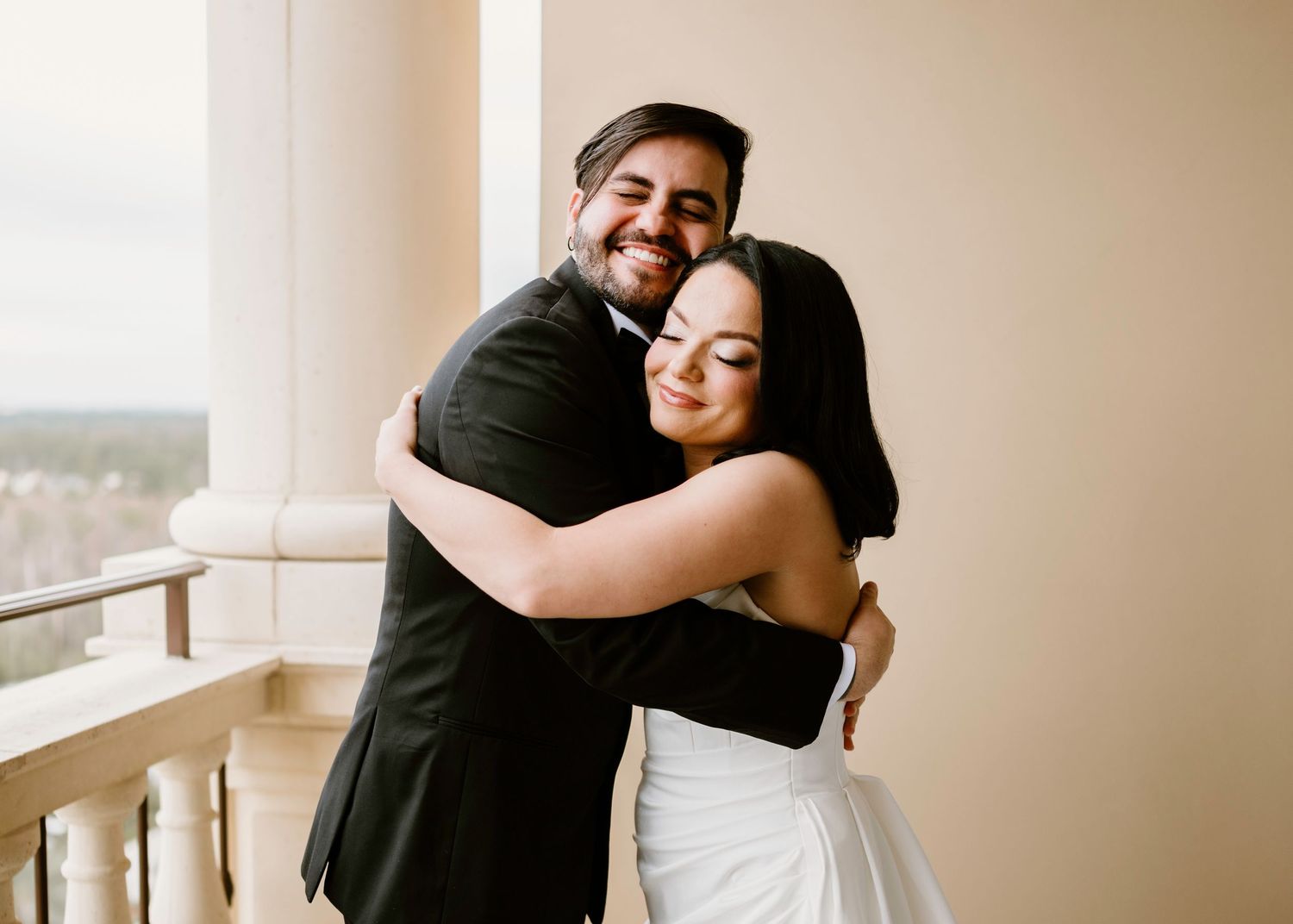 Joyful wedding day embrace captured in sequence on balcony.