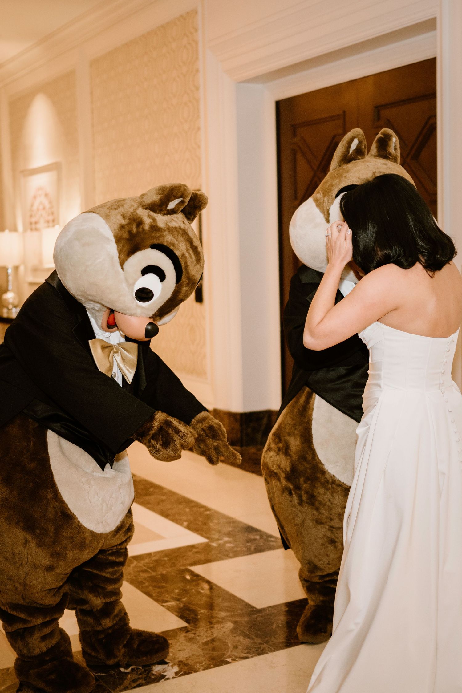 Disney chipmunk characters perform choreographed dance moves with bride in white dress.