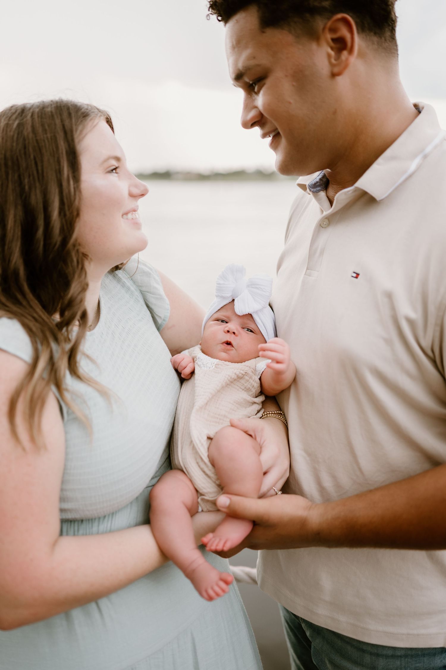 Candid lifestyle photos show parents sharing loving moments with their newborn baby.