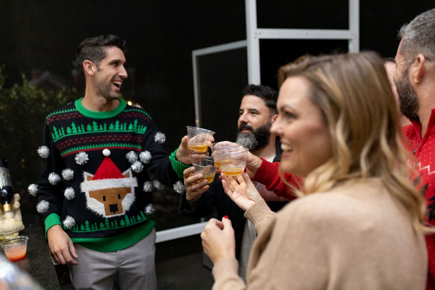 Friends toasting and celebrating at a Christmas party.