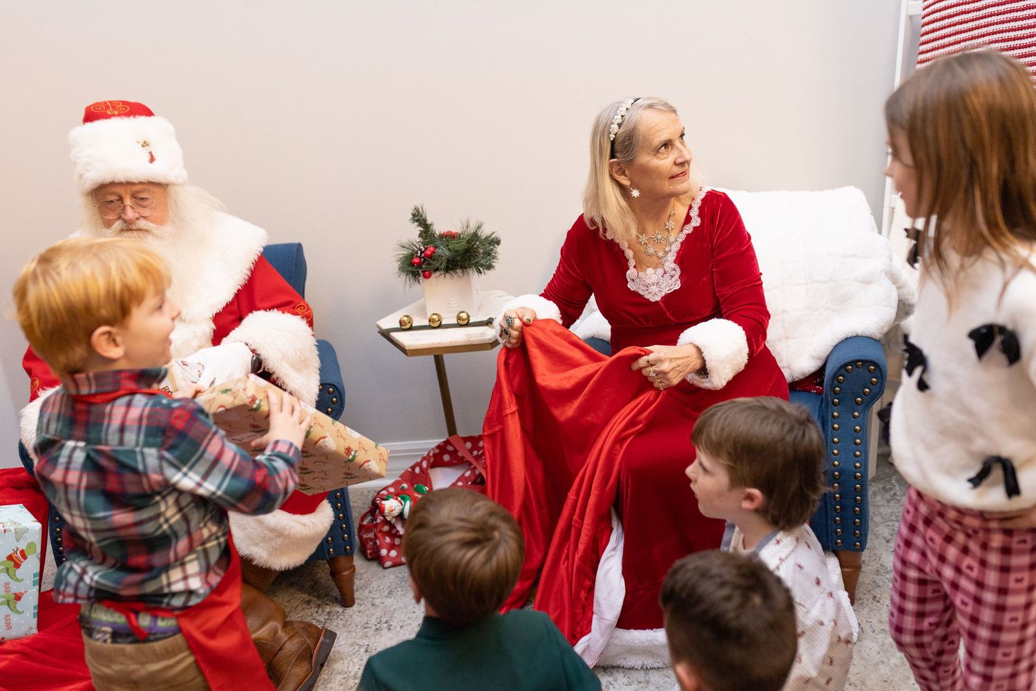 Festive holiday celebration scene with people gathered in a room decorated with Christmas ornaments.
