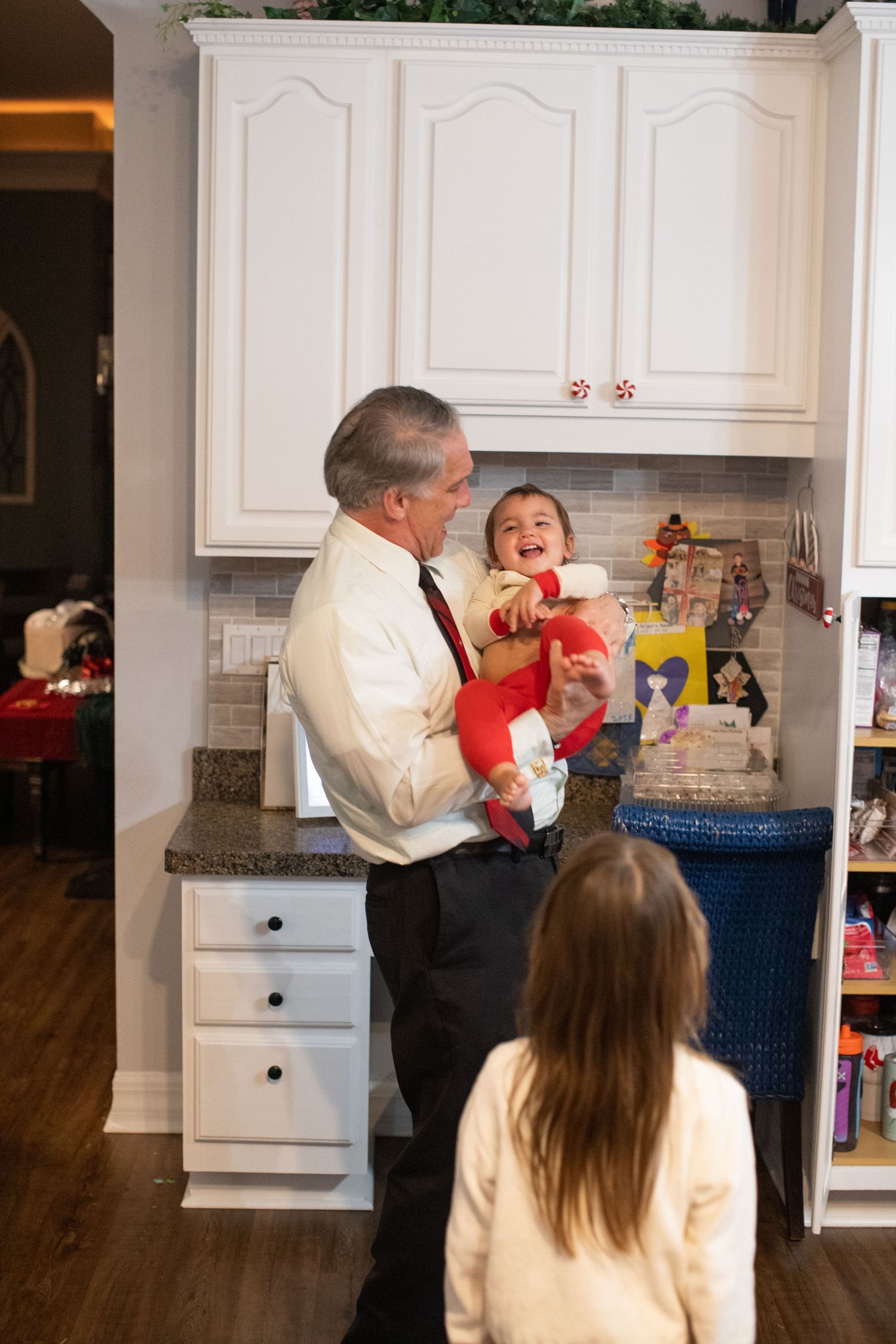 Family shares a joyful moment in the kitchen during holiday celebrations.