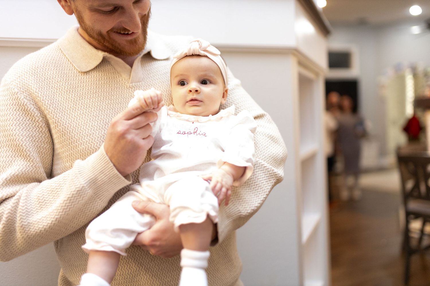 Monochrome series of intimate family moments with a small baby in white.