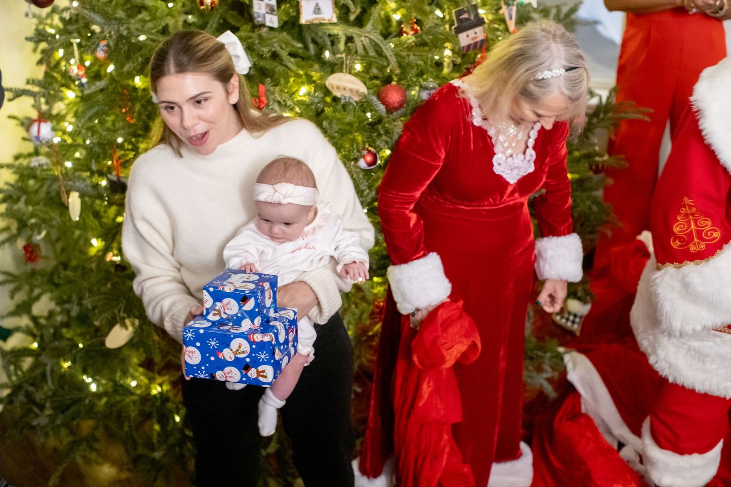 A festive scene with decorated Christmas tree and holiday gift presentation.