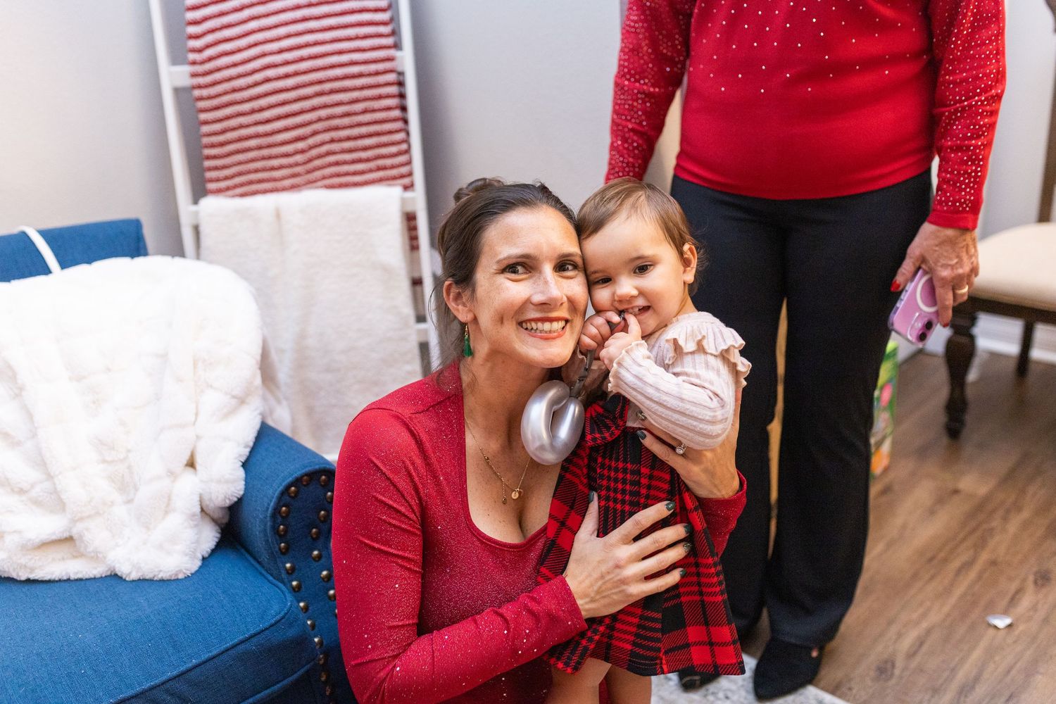A cozy indoor Christmas celebration with red and white holiday decor.