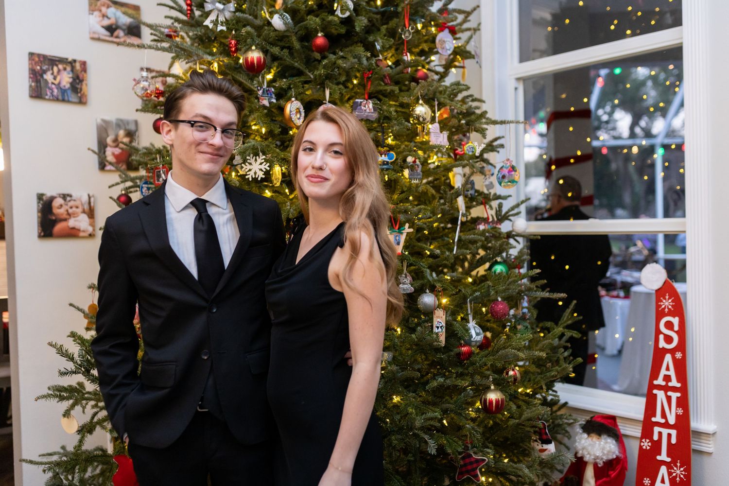 Holiday portraits with Christmas tree backdrop featuring ornaments and twinkling lights.