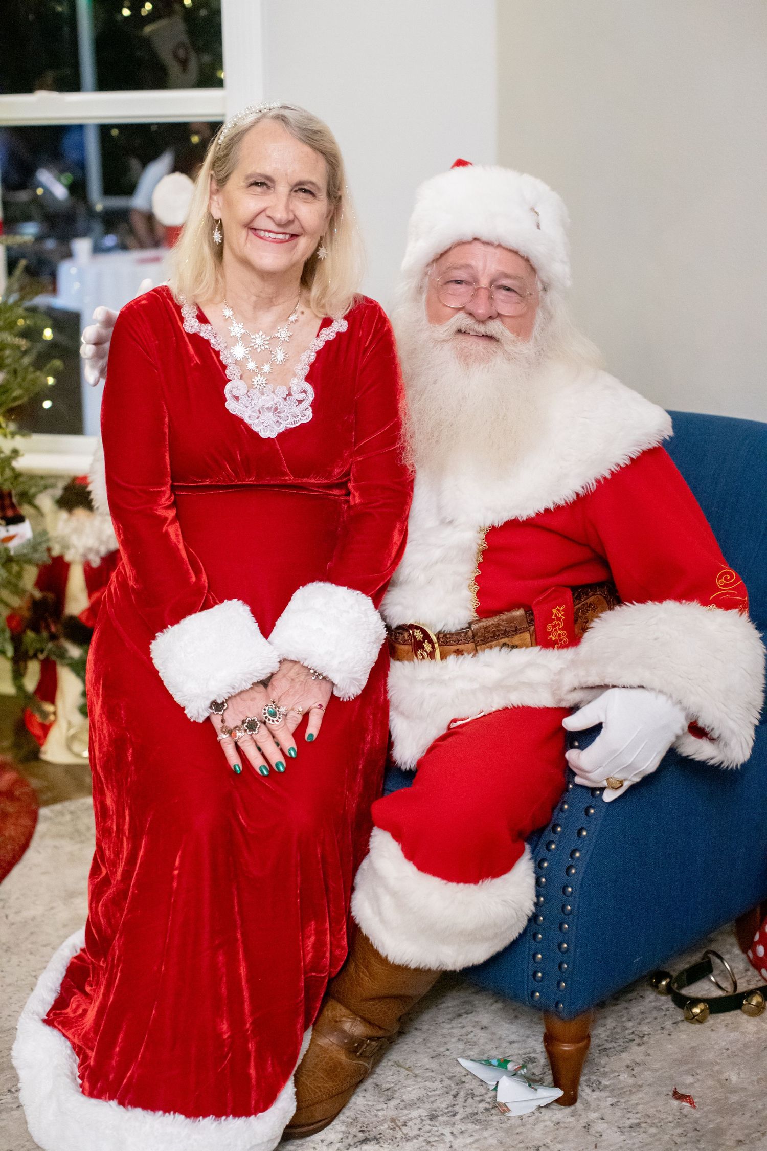 A cozy Christmas scene with traditional holiday decorations and red velvet clothing.