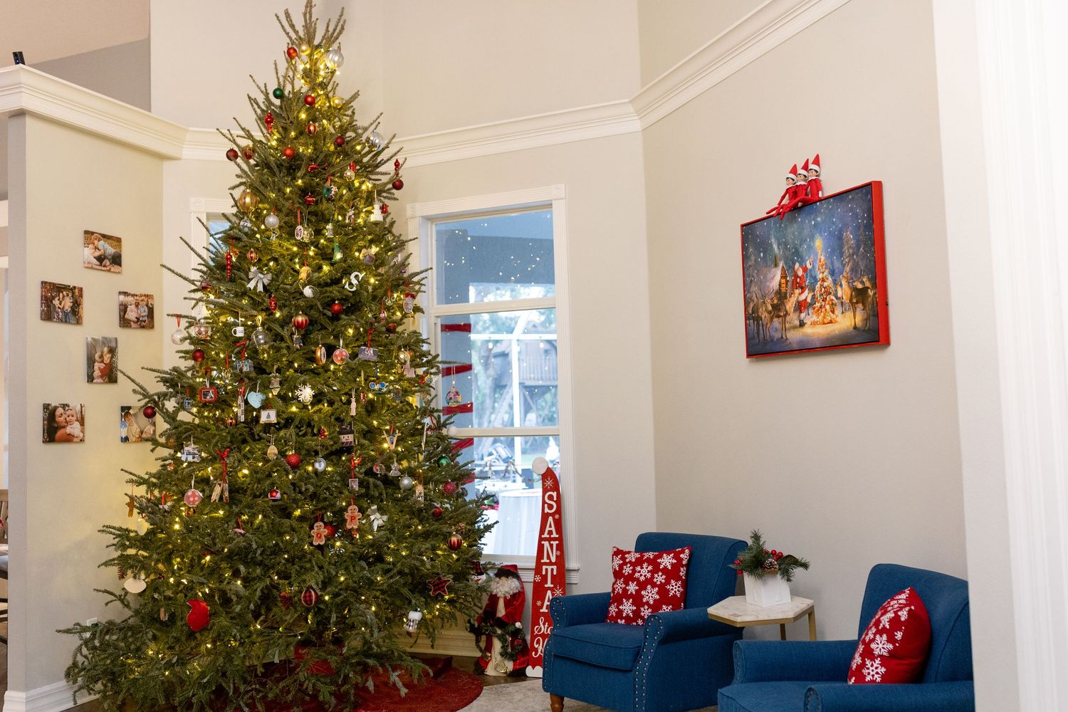 Decorated Christmas tree with lights and ornaments in a bright corner room.