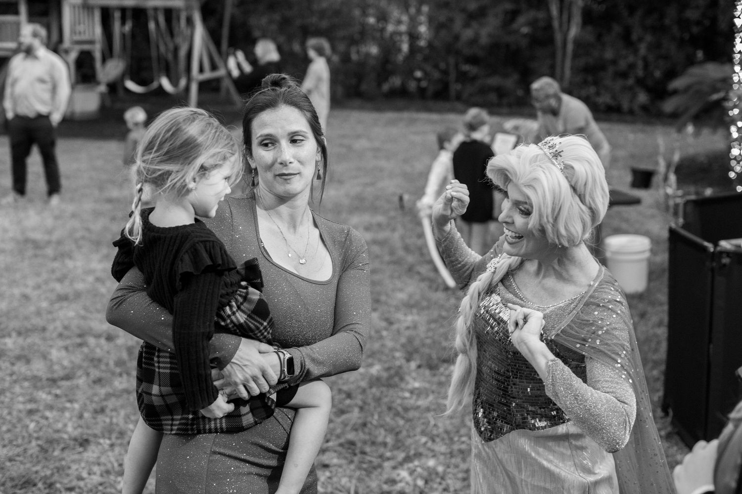Black and white photo series showing candid moments between two people at an outdoor event.