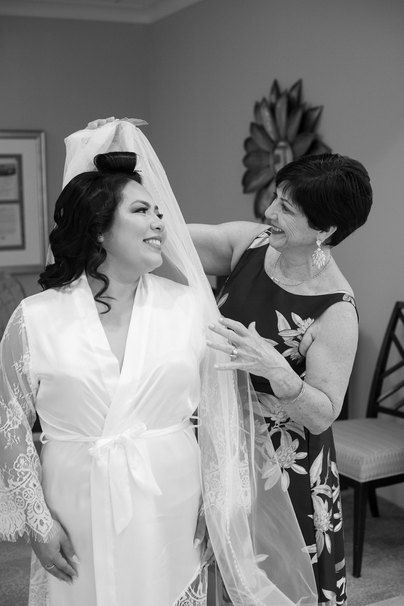 A tender moment captured during wedding preparations in a getting-ready room.