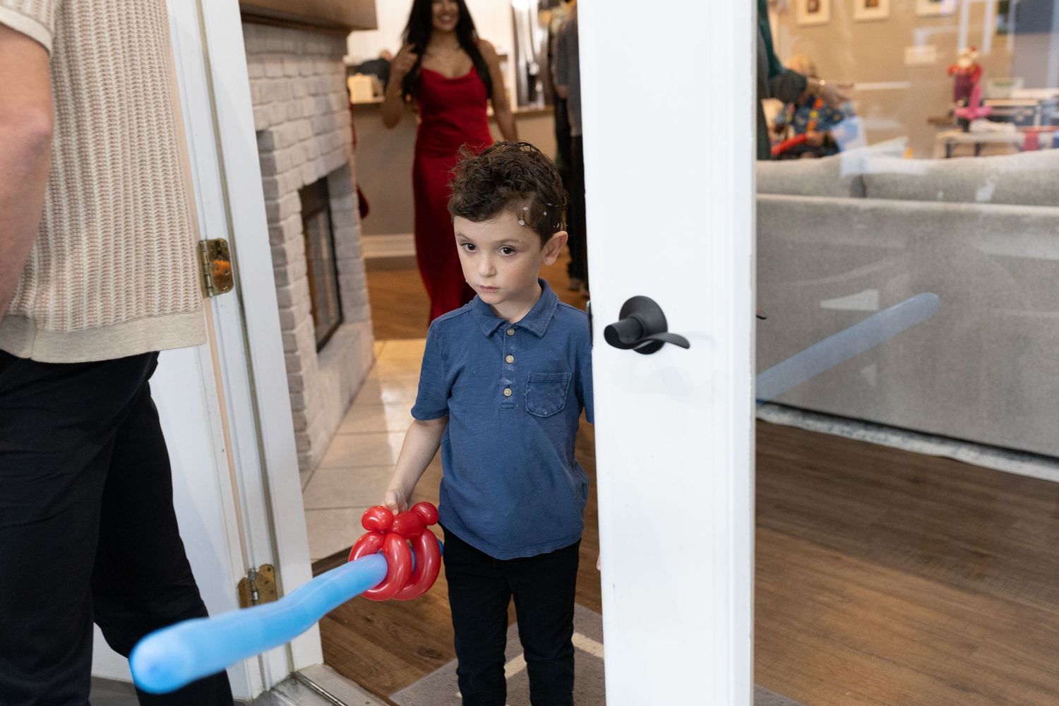 People playing with lightsabers in a festive indoor setting.