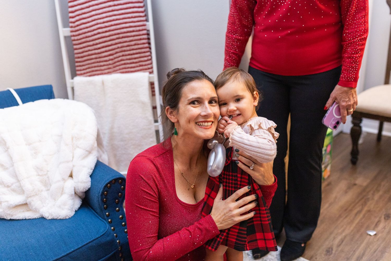 Holiday decorations and festive red clothing create a cheerful Christmas atmosphere.