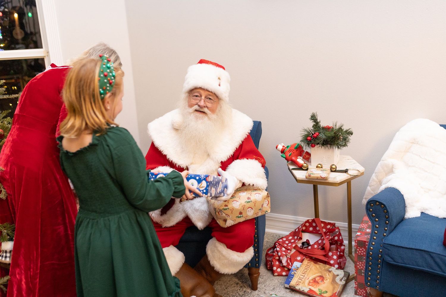 Holiday celebration with decorated Christmas trees and festive decor in the background.