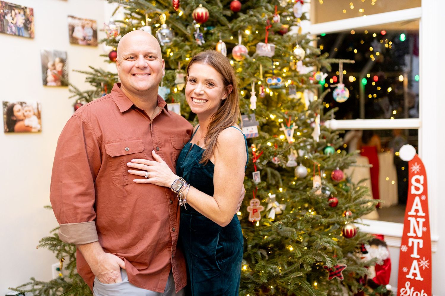 Festive indoor photo shoot with decorated Christmas tree and holiday decor.