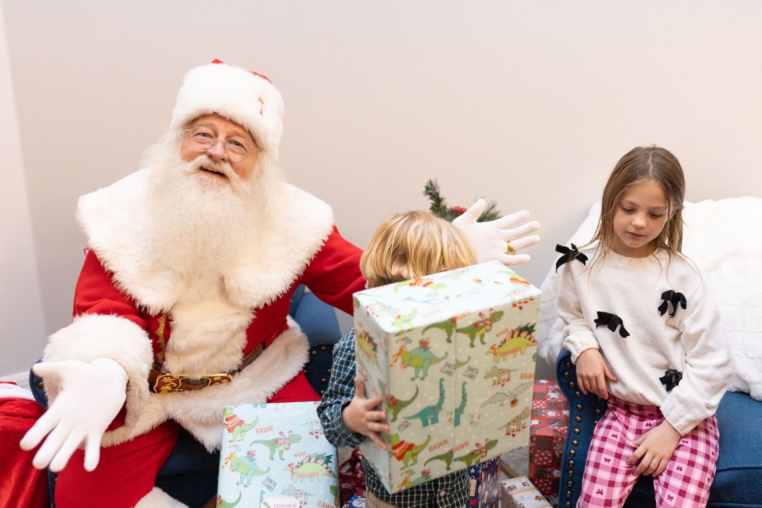 Holiday celebration with wrapped presents and festive decorations against a light background.