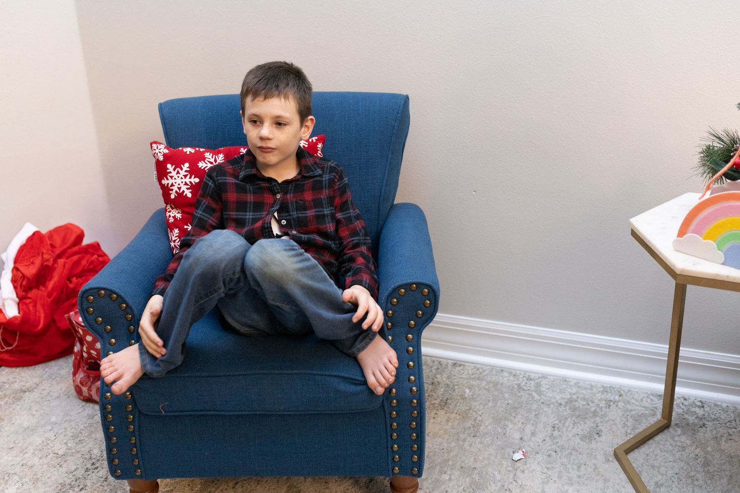 A casual scene showing someone relaxing on a blue upholstered chair.