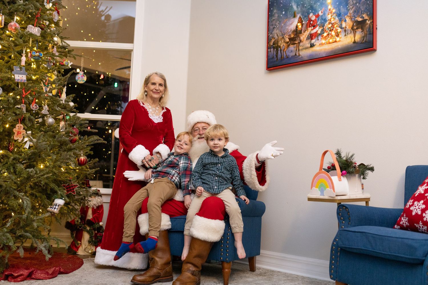 Christmas gathering in a bright room with a decorated tree and blue furniture.