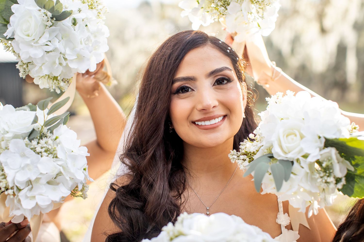 White floral wedding decorations and bouquets create an elegant outdoor ceremony setting.