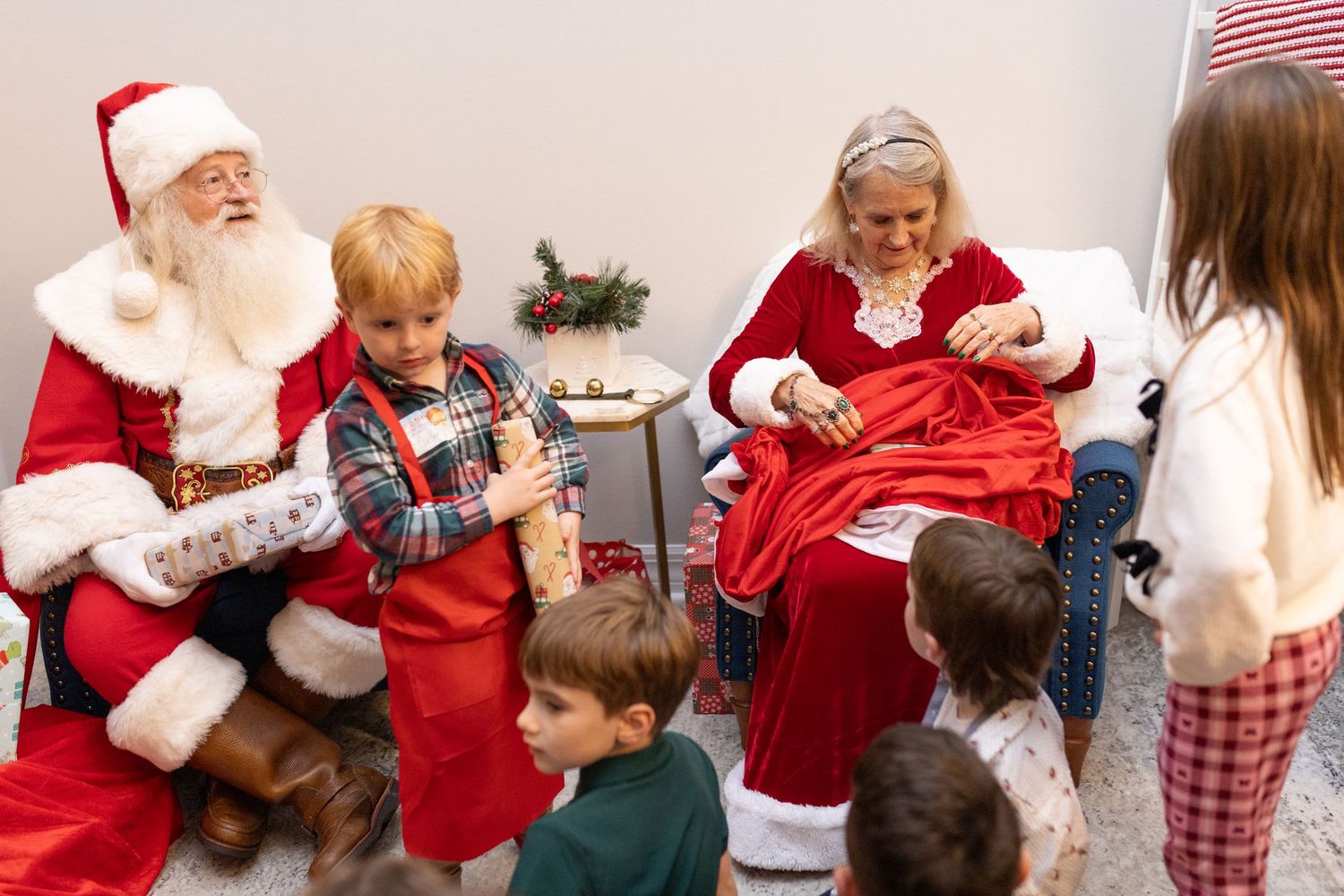 Holiday celebration with festive decorations and people gathered around in seasonal attire.