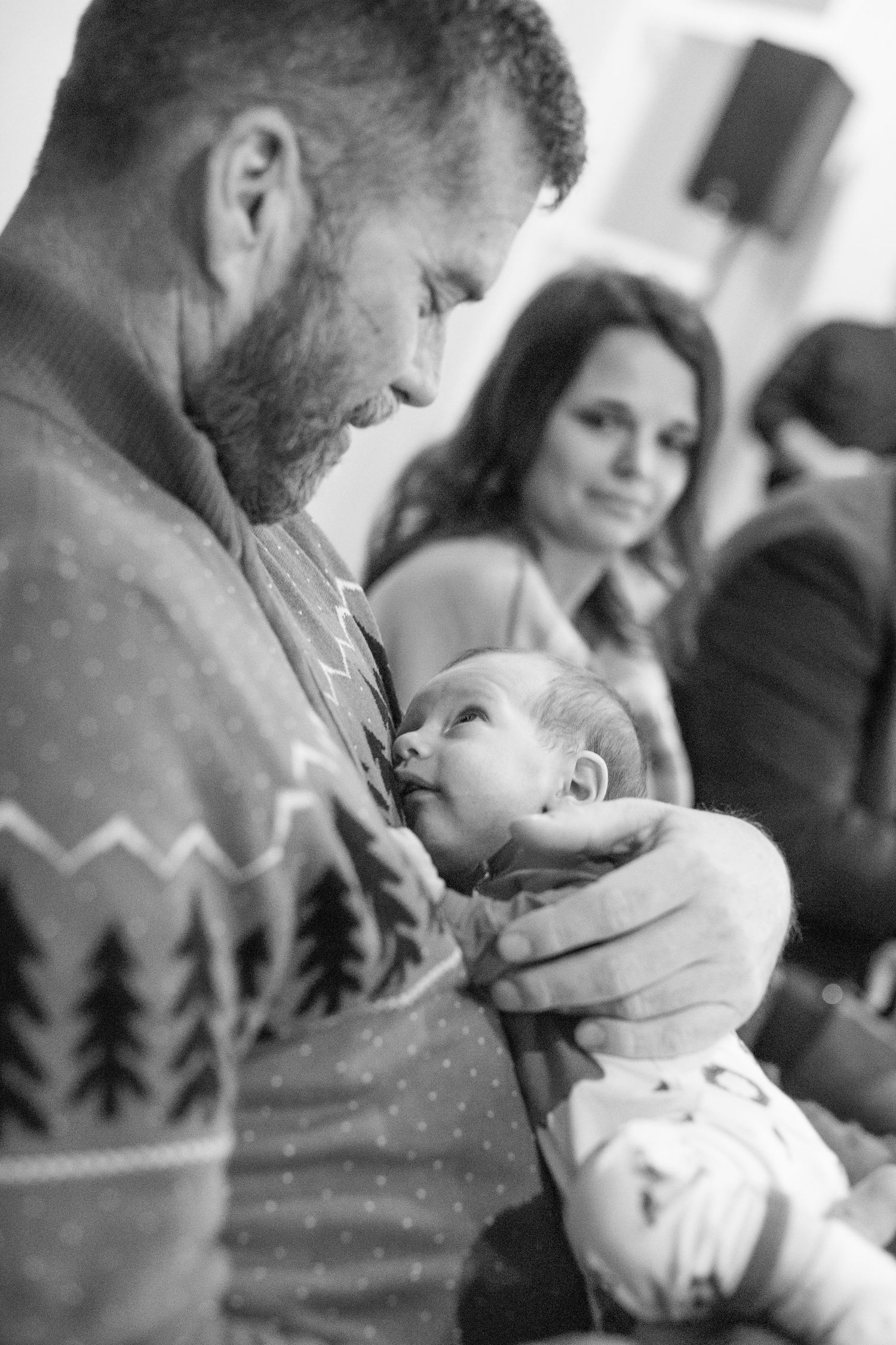 Black and white portrait showing tender moments during a winter celebration.