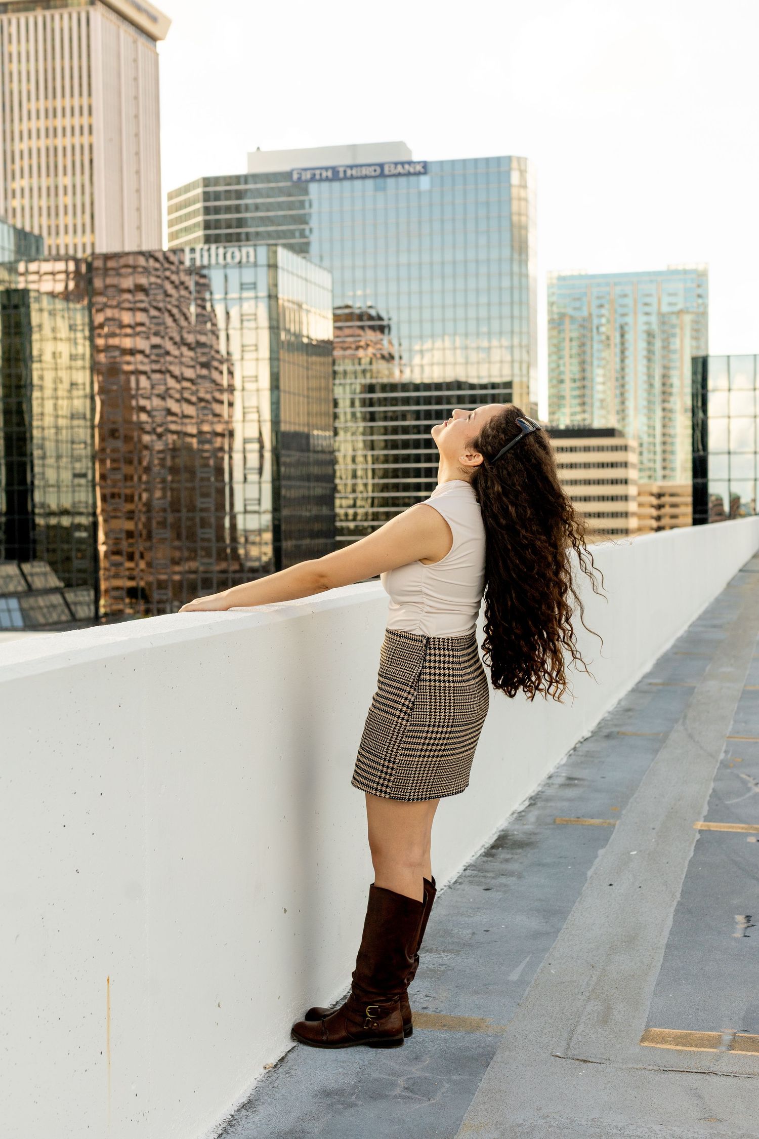 Urban rooftop portrait with city skyline backdrop and modern architecture.